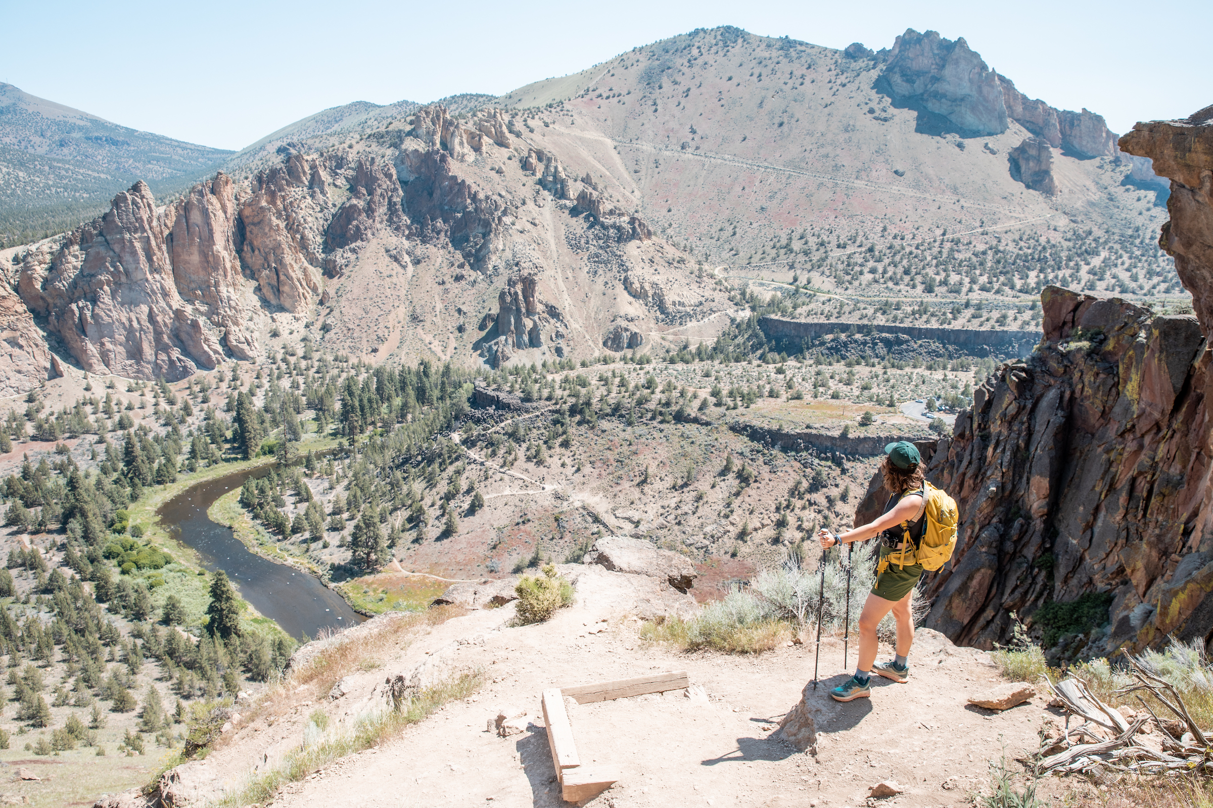 AdventurUs Woman standing on Misery Ridge at Smith Rock State Park looking at the view.